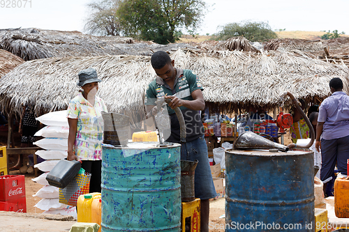 Image of Man sell petrol on rural Madagascar marketplace