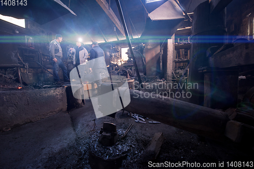 Image of old mechanical hammer at blacksmith traditional workshop