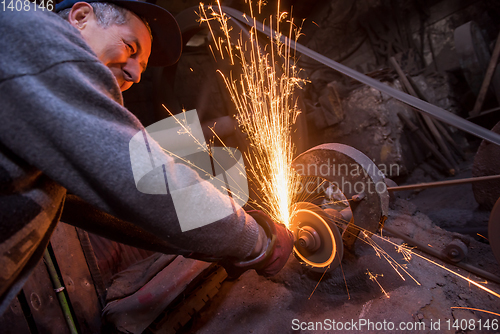 Image of the blacksmith polishing metal products