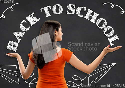 Image of Half-length close up portrait of young woman, back to school