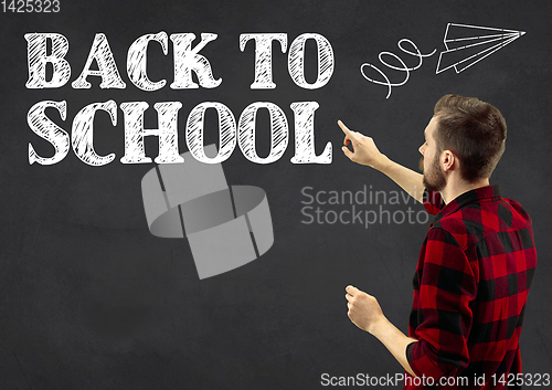 Image of Half-length close up portrait of young man, back to school