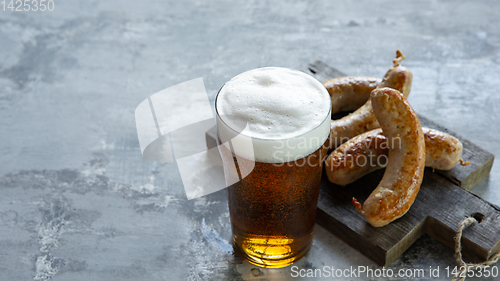 Image of Glass of beer on white stone background