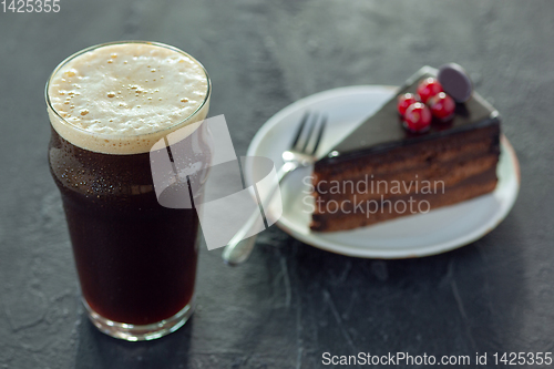 Image of Glass of dark beer on the stone table background