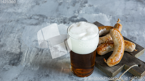 Image of Glass of beer on white stone background