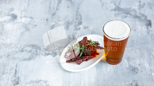 Image of Glass of beer on the stone table and brick\'s background