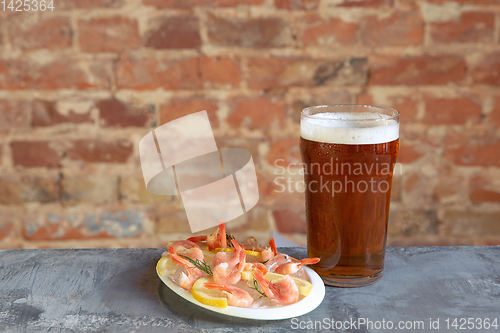 Image of Glass of light beer on white stone background