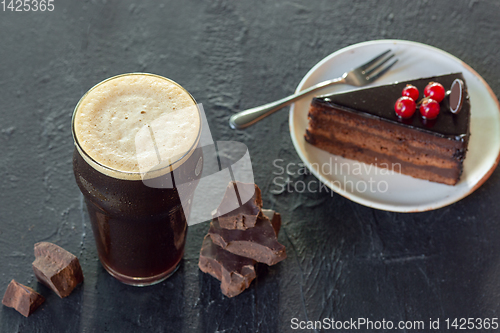 Image of Glass of dark beer on the stone table background