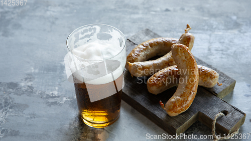 Image of Glass of beer on white stone background