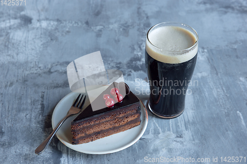Image of Glass of dark beer on the stone table background