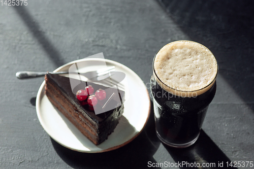 Image of Glass of dark beer on the stone table background