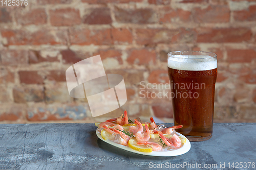 Image of Glass of light beer on white stone background