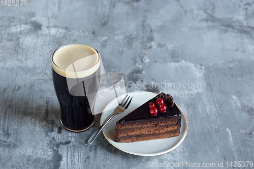 Image of Glass of dark beer on the stone table background