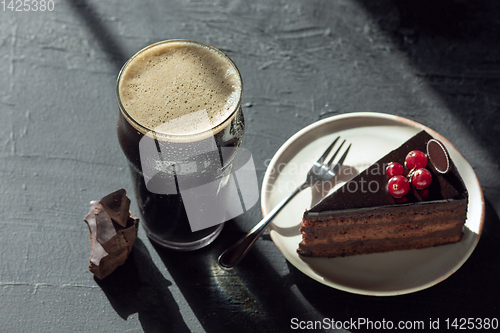 Image of Glass of dark beer on the stone table background