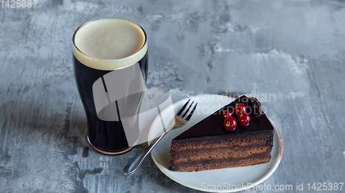 Image of Glass of dark beer on the stone table background