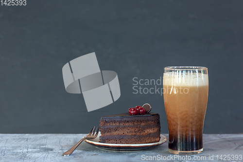 Image of Glass of dark beer on the stone table background