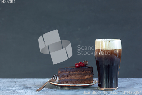 Image of Glass of dark beer on the stone table background