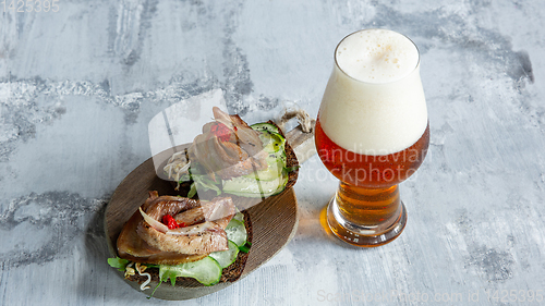 Image of Glass of beer on the stone table and brick\'s background