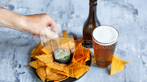 Image of Glass of light beer on white stone background