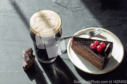 Image of Glass of dark beer on the stone table background