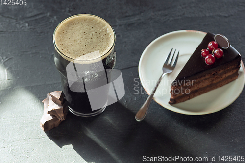 Image of Glass of dark beer on the stone table background