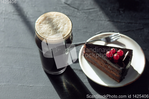 Image of Glass of dark beer on the stone table background