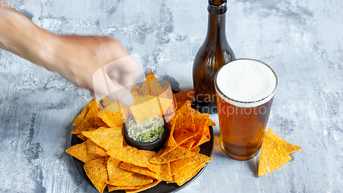 Image of Glass of light beer on white stone background