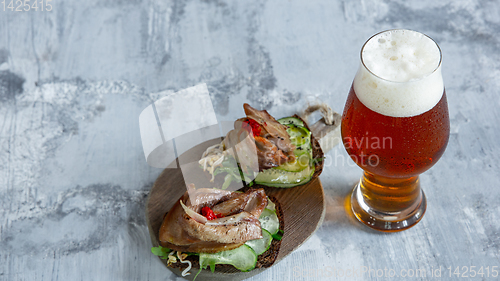 Image of Glass of beer on the stone table and brick\'s background