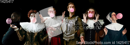 Image of Young people as a medieval knights or grandees on dark background