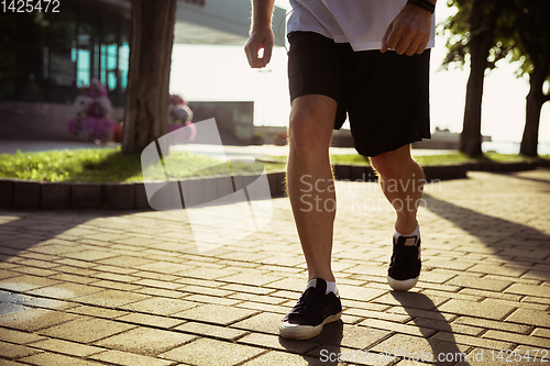 Image of Senior man as runner with armband or fitness tracker at the city\'s street