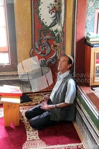 Image of Muslim man reading the Koran in the Aladza painted mosque,Tetovo, Macedonia
