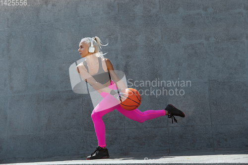 Image of A young athletic woman working out at the city\'s street