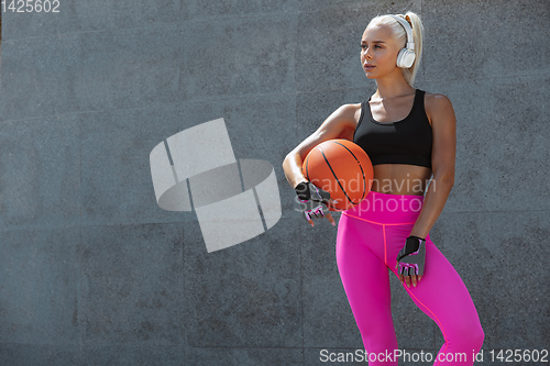 Image of A young athletic woman working out at the city\'s street