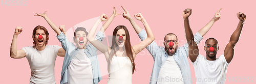 Image of Portrait of young people celebrating red nose day on coral background
