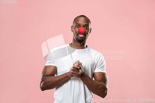 Image of Portrait of young african-american man smiling. Red nose day celebrating