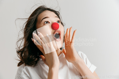 Image of Portrait of beautiful woman looking suprised. Red nose day celebrating