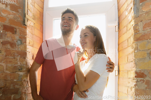 Image of Young couple doing apartment repair together themselves