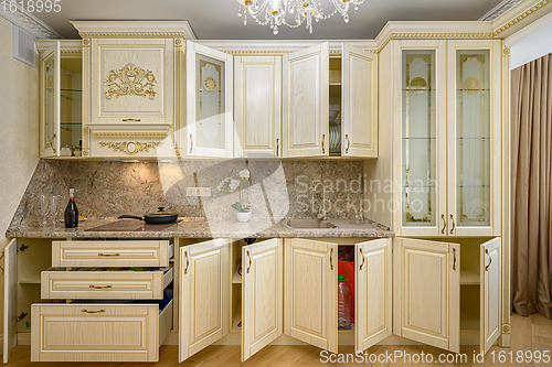 Image of Front view of luxury modern neoclassic beige kitchen interior