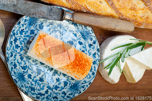 Image of French cheese and fresh  baguette on a wood cutter