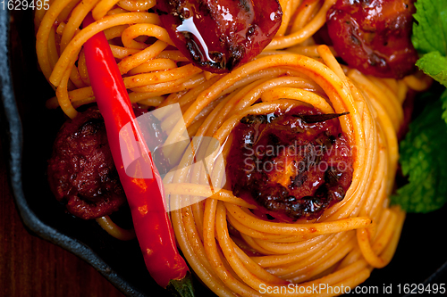 Image of italian spaghetti pasta and tomato with mint leaves 