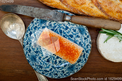 Image of French cheese and fresh  baguette on a wood cutter