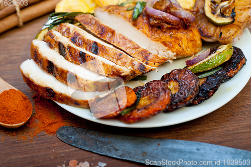 Image of roasted grilled BBQ chicken breast with herbs and spices 