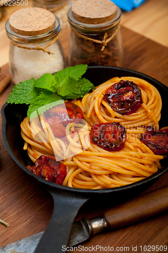 Image of italian spaghetti pasta and tomato with mint leaves 