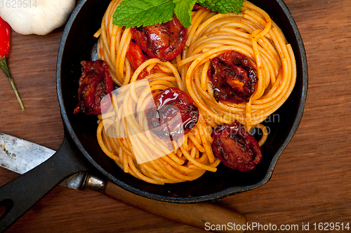 Image of italian spaghetti pasta and tomato with mint leaves 