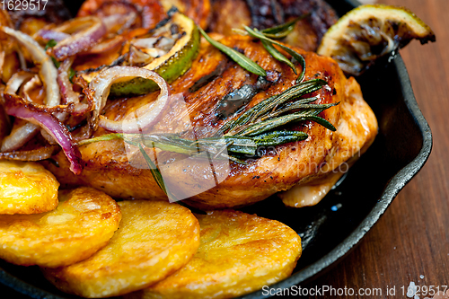Image of roasted grilled BBQ chicken breast with herbs and spices 