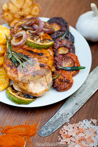Image of roasted grilled BBQ chicken breast with herbs and spices 