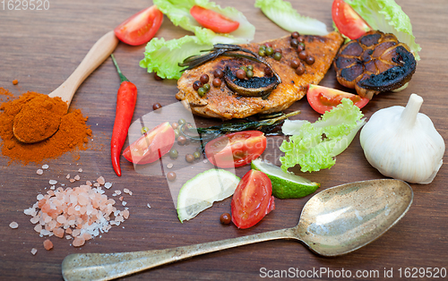 Image of wood fired hoven cooked chicken breast on wood board 