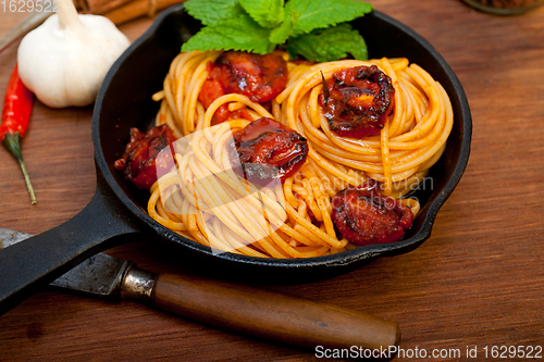Image of italian spaghetti pasta and tomato with mint leaves 