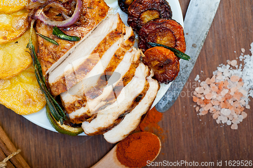 Image of roasted grilled BBQ chicken breast with herbs and spices 