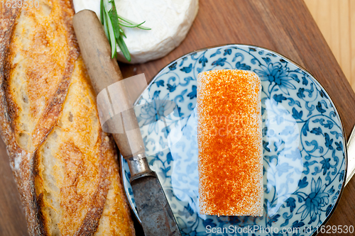 Image of French cheese and fresh  baguette on a wood cutter