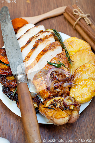 Image of roasted grilled BBQ chicken breast with herbs and spices 